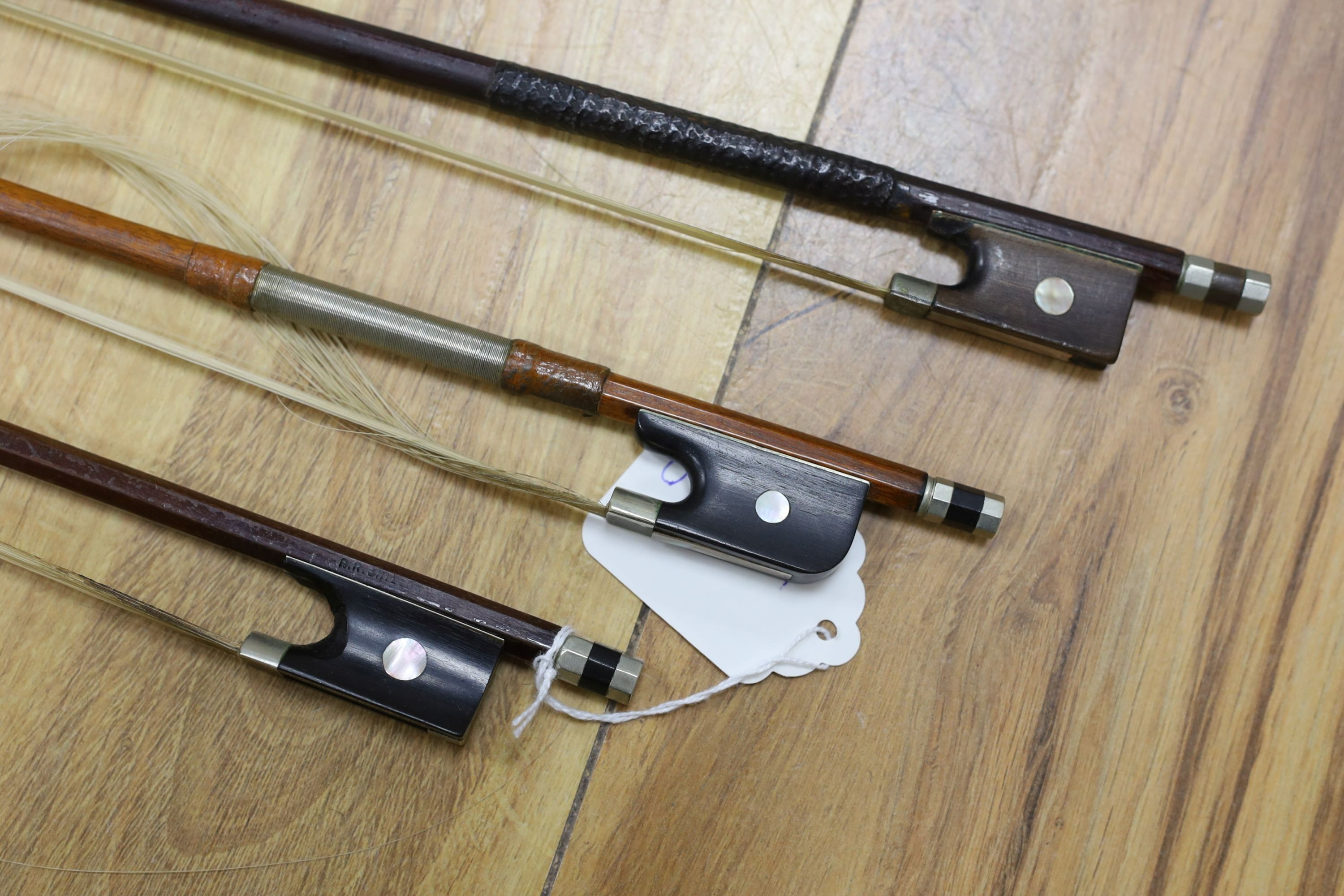 Three nickel mounted violin bows, one stamped R. R. Shields, two with ivory veneered tip - longest 75cm